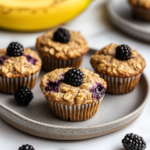 Moist banana blackberry oatmeal muffins with golden crust.